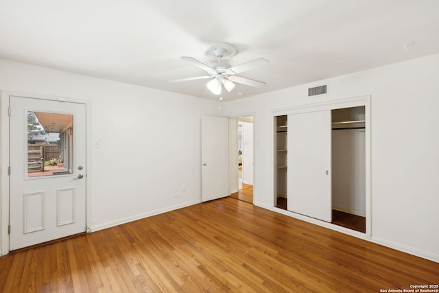 unfurnished bedroom with a closet, ceiling fan, and hardwood / wood-style flooring