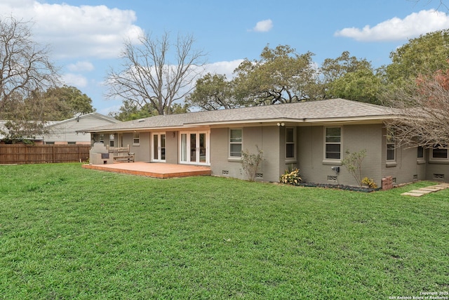 back of property with a lawn and a patio