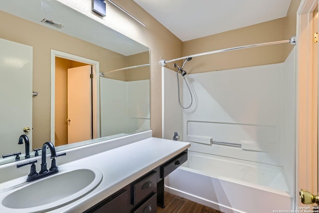 bathroom with vanity, tub / shower combination, and hardwood / wood-style floors