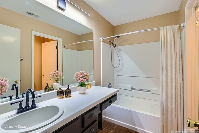 bathroom with vanity, hardwood / wood-style floors, and shower / bathtub combination with curtain