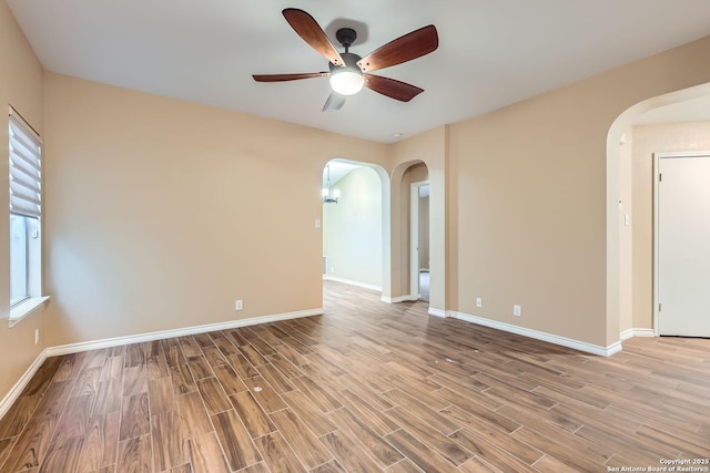 empty room with ceiling fan and hardwood / wood-style floors