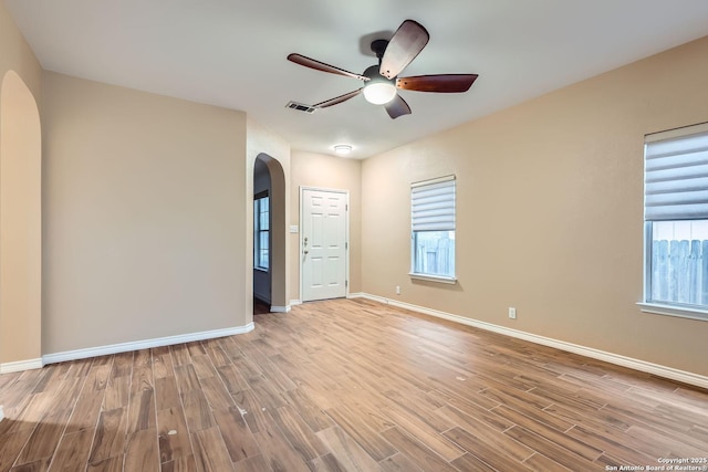 unfurnished room with ceiling fan, plenty of natural light, and light hardwood / wood-style floors