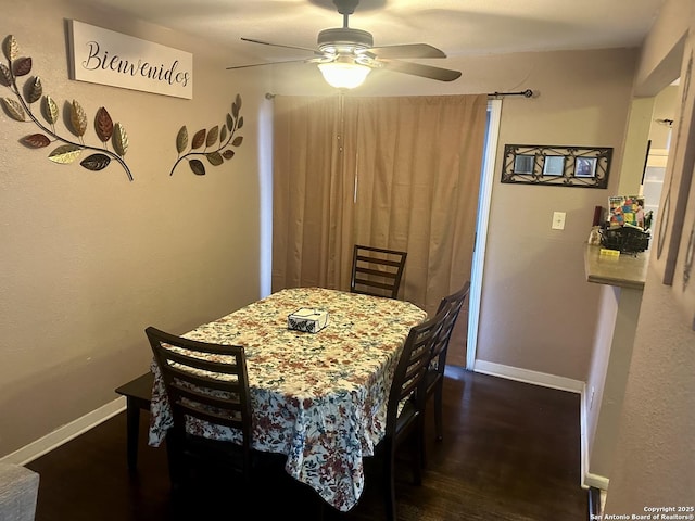 dining space featuring ceiling fan and dark hardwood / wood-style flooring