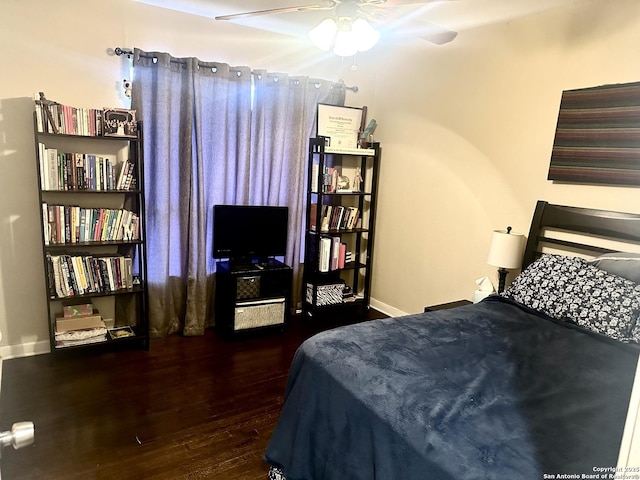 bedroom with ceiling fan and dark hardwood / wood-style floors