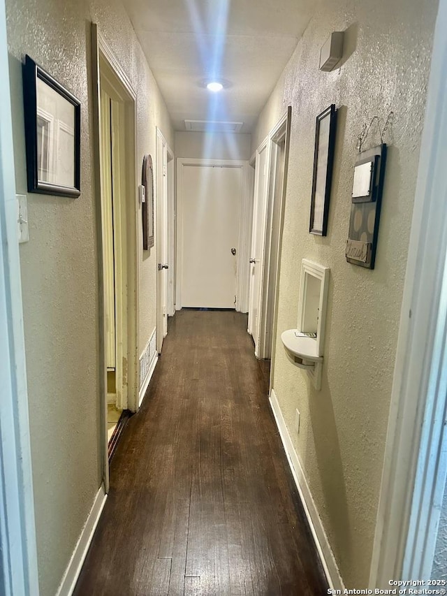 corridor featuring dark hardwood / wood-style floors