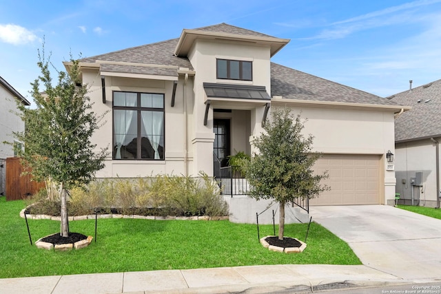 prairie-style home featuring a front lawn and a garage