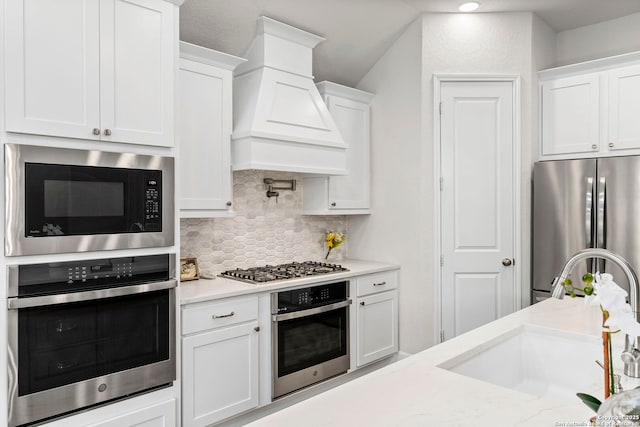 kitchen with stainless steel appliances and white cabinetry