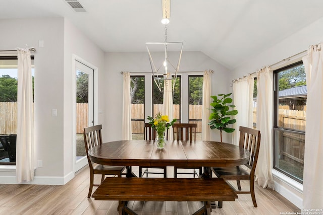 dining room featuring vaulted ceiling