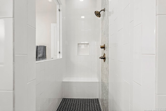 bathroom with tiled shower