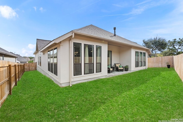 rear view of property featuring a lawn