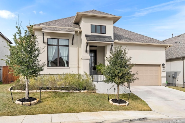 view of front of property featuring a front yard and a garage