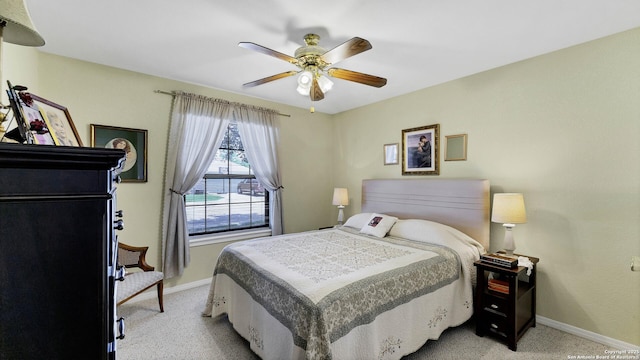 bedroom with ceiling fan and light colored carpet