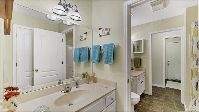 bathroom featuring toilet, vanity, and an inviting chandelier