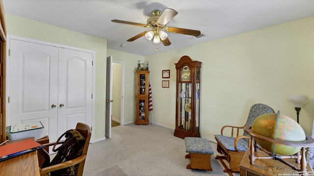 carpeted home office with ceiling fan