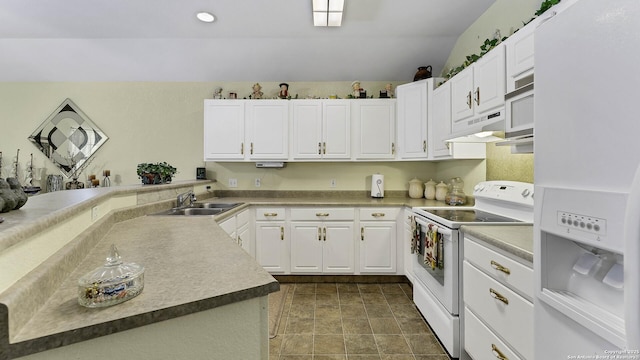 kitchen featuring white appliances, kitchen peninsula, white cabinets, lofted ceiling, and sink