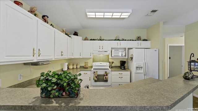 kitchen featuring lofted ceiling, white appliances, white cabinets, and kitchen peninsula