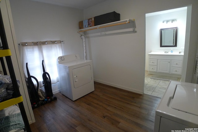 laundry room with washing machine and dryer and dark hardwood / wood-style flooring