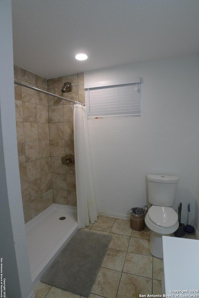 bathroom with toilet, tile patterned flooring, and a shower with curtain