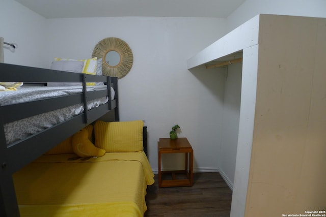 bedroom with dark hardwood / wood-style flooring