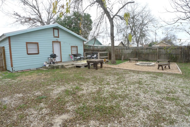 view of yard featuring a wooden deck and a fire pit