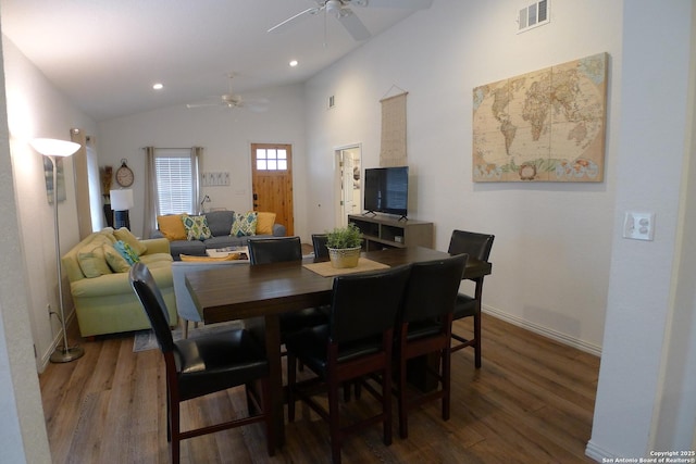 dining space featuring ceiling fan, wood-type flooring, and lofted ceiling