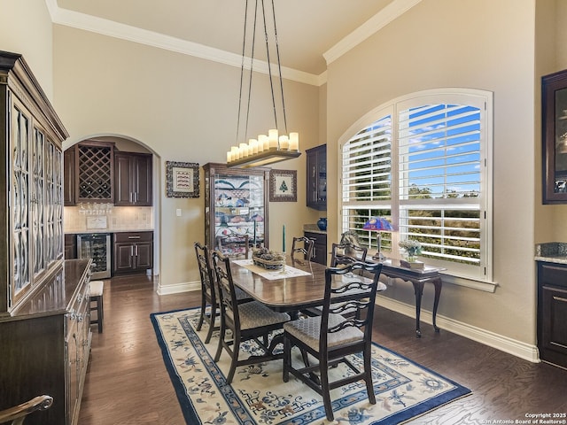 dining room featuring bar, crown molding, dark wood-type flooring, and wine cooler