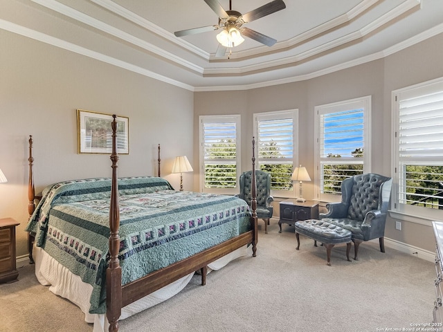 carpeted bedroom featuring ceiling fan, ornamental molding, and a raised ceiling