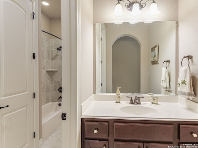 bathroom with vanity and tiled shower / bath combo