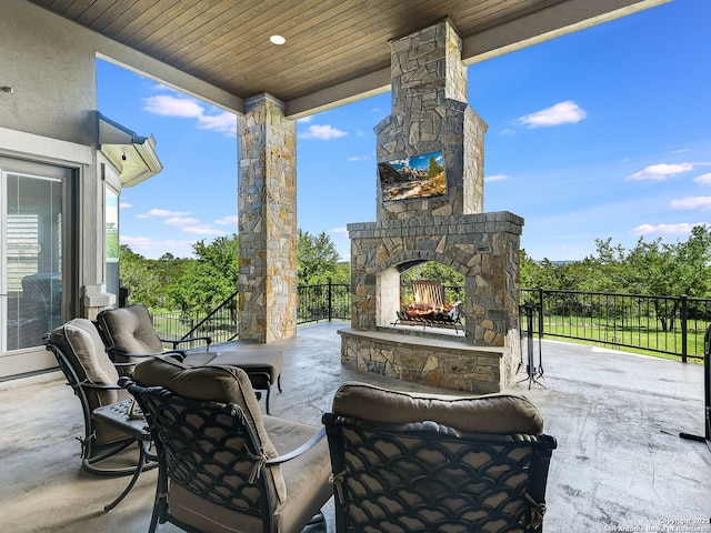 view of patio with an outdoor stone fireplace