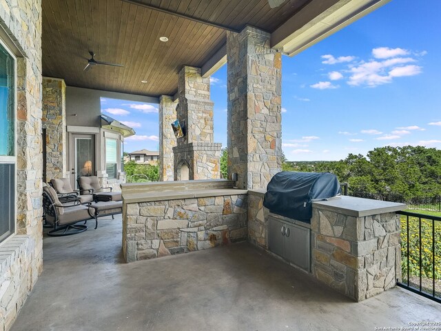 view of patio / terrace with ceiling fan, a grill, and exterior kitchen