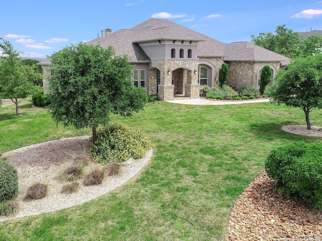 mediterranean / spanish home featuring a front yard