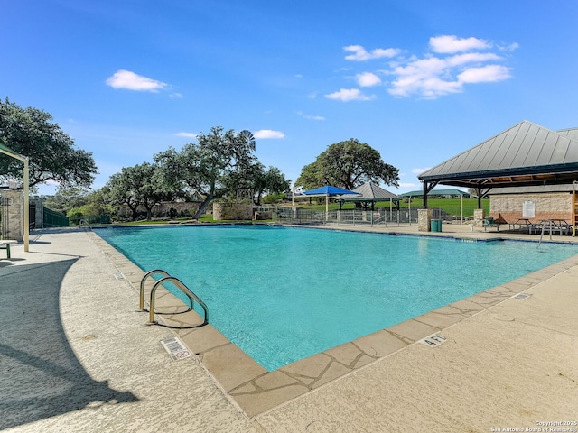 view of swimming pool featuring a patio and a gazebo