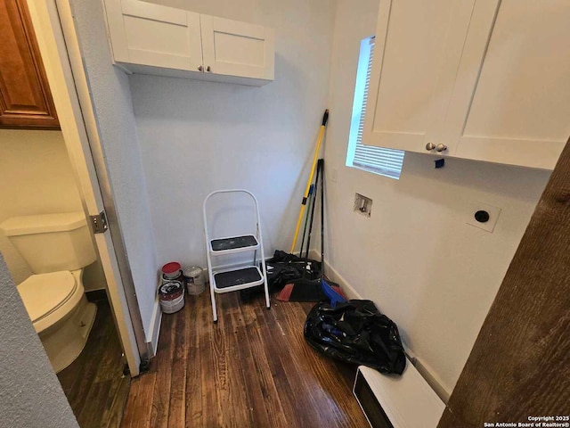 laundry area featuring hookup for an electric dryer, cabinets, and dark wood-type flooring