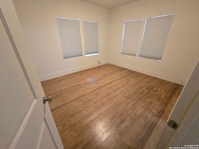 empty room featuring wood-type flooring