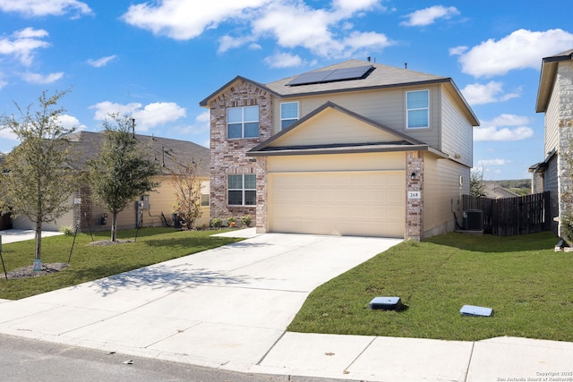 front of property with solar panels, central AC, a front lawn, and a garage