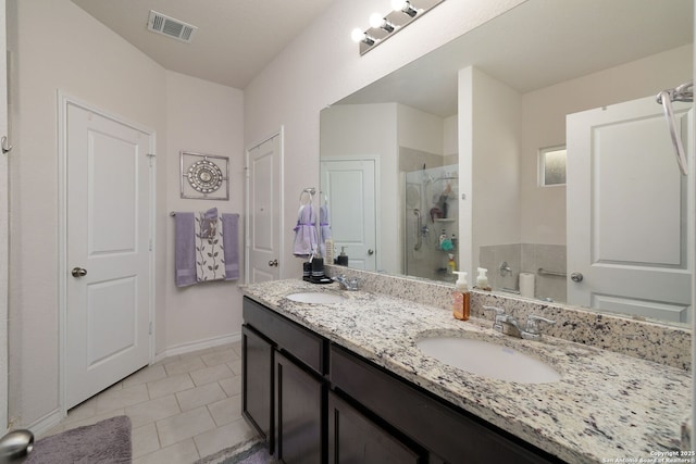 bathroom with vanity, walk in shower, and tile patterned flooring