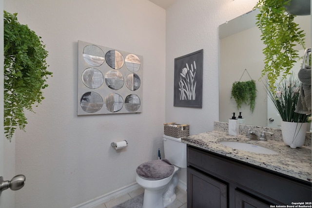 bathroom featuring toilet, vanity, and tile patterned floors