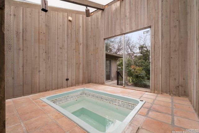 view of swimming pool featuring an in ground hot tub