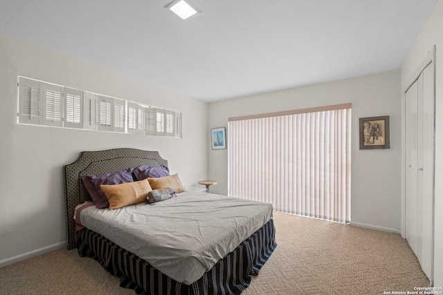 bedroom featuring a closet and light carpet