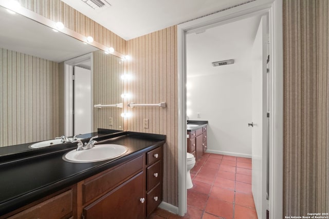 bathroom featuring tile patterned flooring, vanity, and toilet