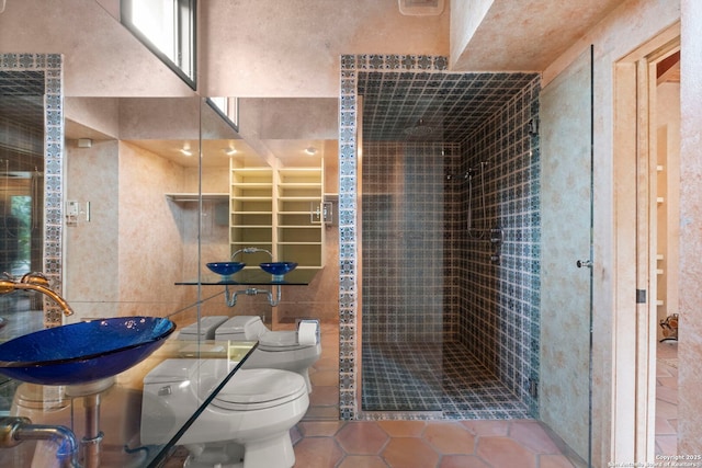 bathroom featuring toilet, a shower, tile patterned floors, and sink