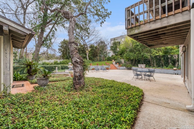 view of yard featuring a patio area and a balcony