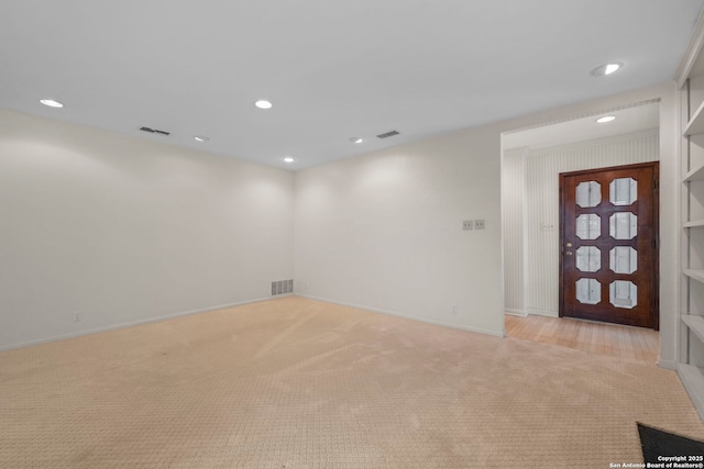 carpeted empty room with built in shelves