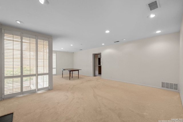 unfurnished room featuring light carpet