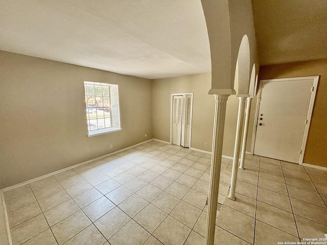 spare room featuring light tile patterned flooring