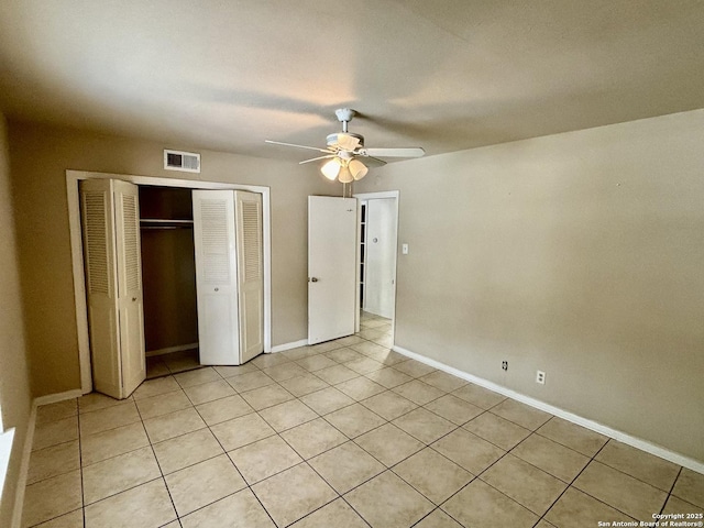 unfurnished bedroom featuring ceiling fan, a closet, and light tile patterned floors