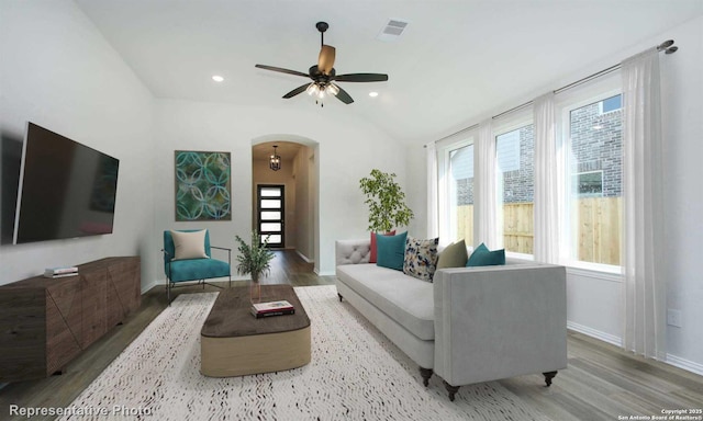 living room with lofted ceiling, ceiling fan, and wood-type flooring