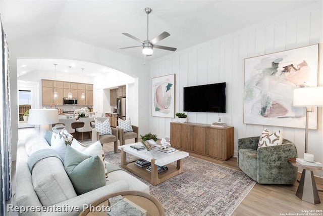 living room with light wood-type flooring and ceiling fan