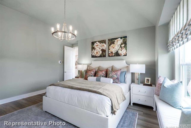 bedroom with a chandelier and dark hardwood / wood-style flooring