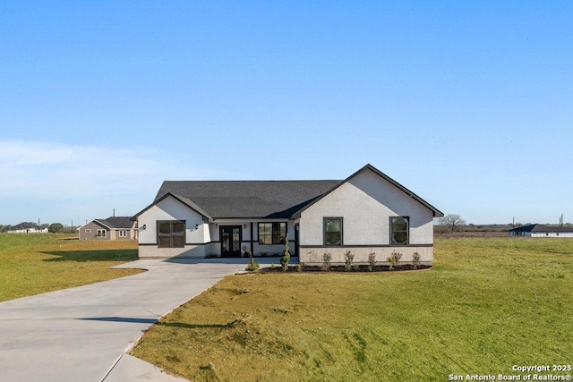 modern farmhouse style home with a front lawn